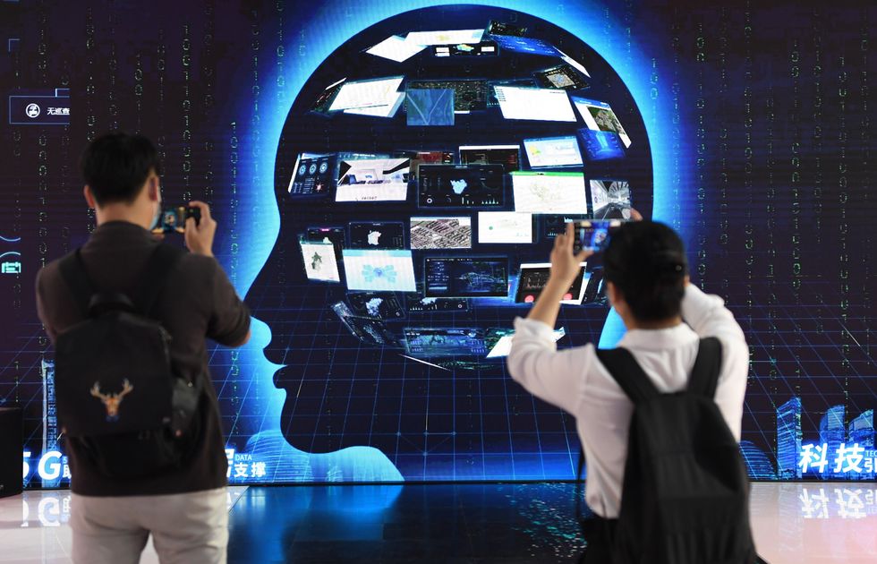 Image of people watching an exhibit at the 23rd China Beijing International High-tech Expo in Beijing, China.