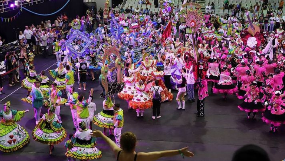 Image of people wearing costumes and dancing in the street in Portugal.