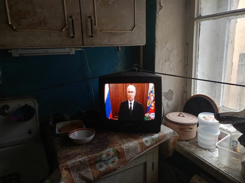 Image of President Vladimir Putin being seen on TV making an appeal to the citizens of Russia