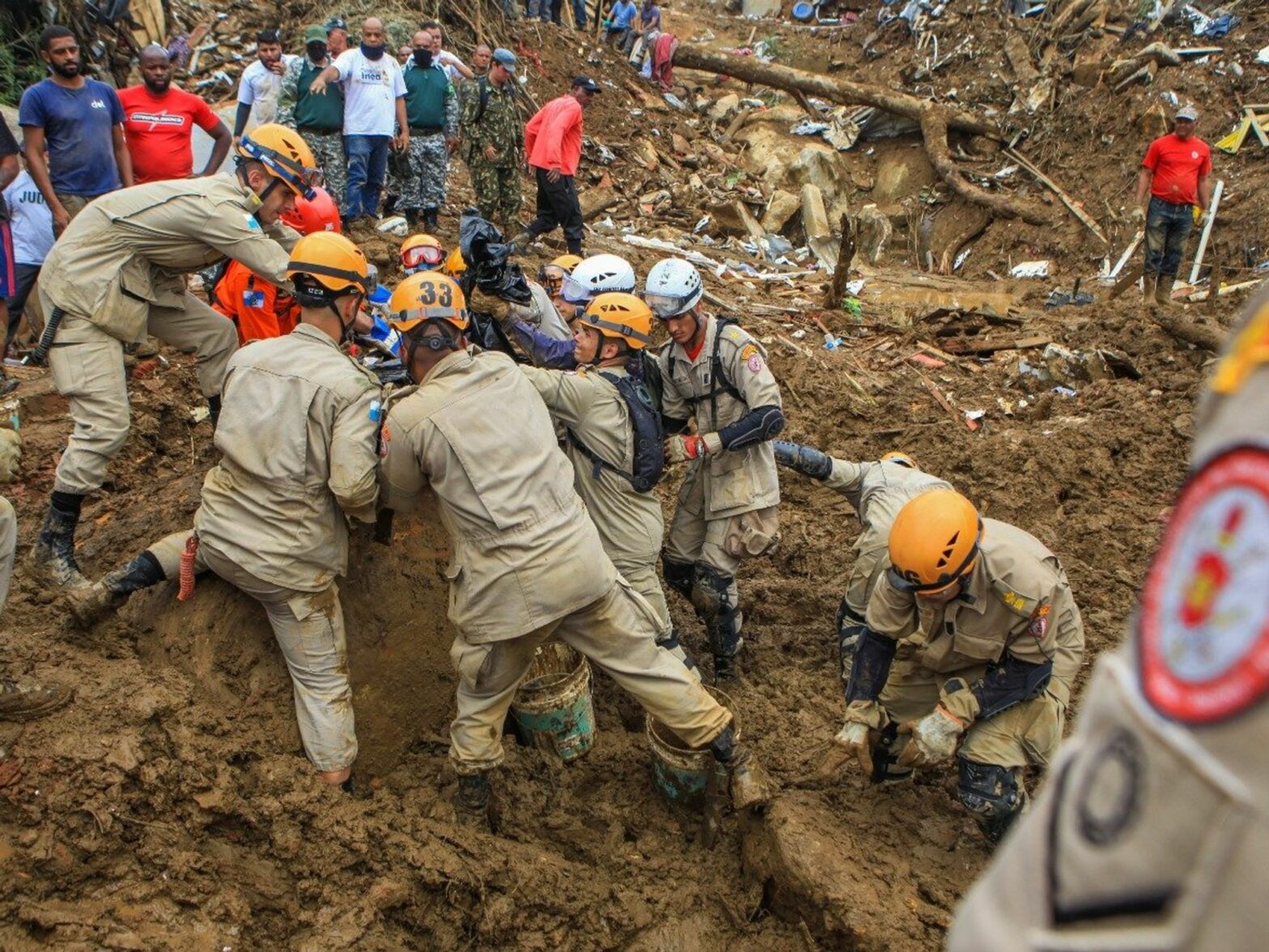 Image of rescuers helping victims of mudslides that had catastrophic consequences on both infrastructure and citizens.