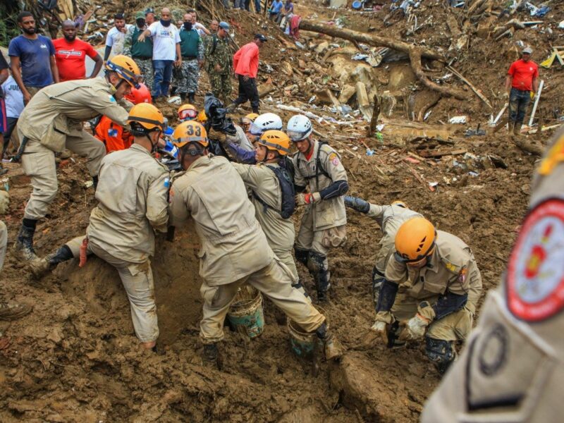 Image of rescuers helping victims of mudslides that had catastrophic consequences on both infrastructure and citizens.
