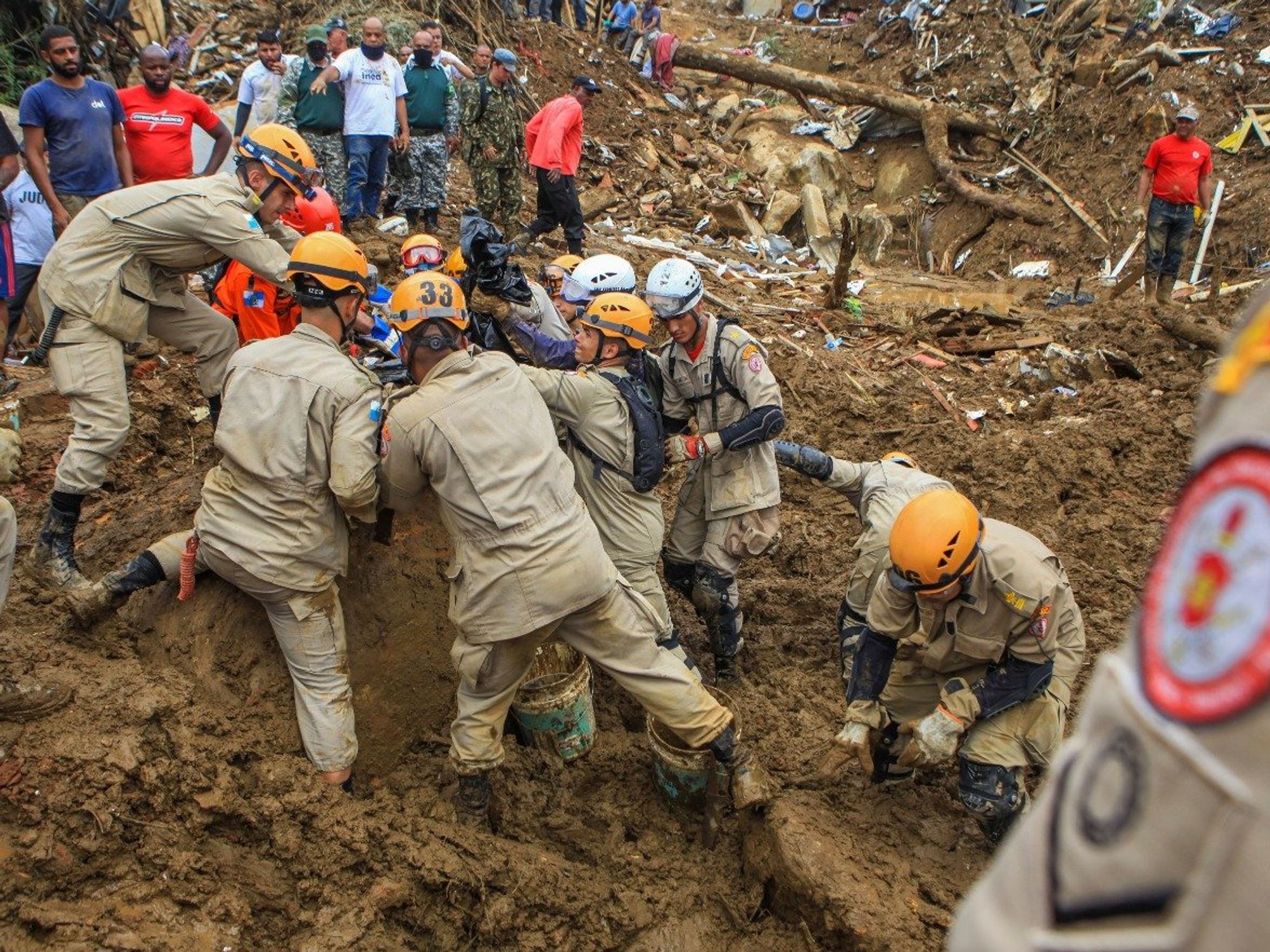 Image of rescuers helping victims of mudslides that had catastrophic consequences on both infrastructure and citizens.