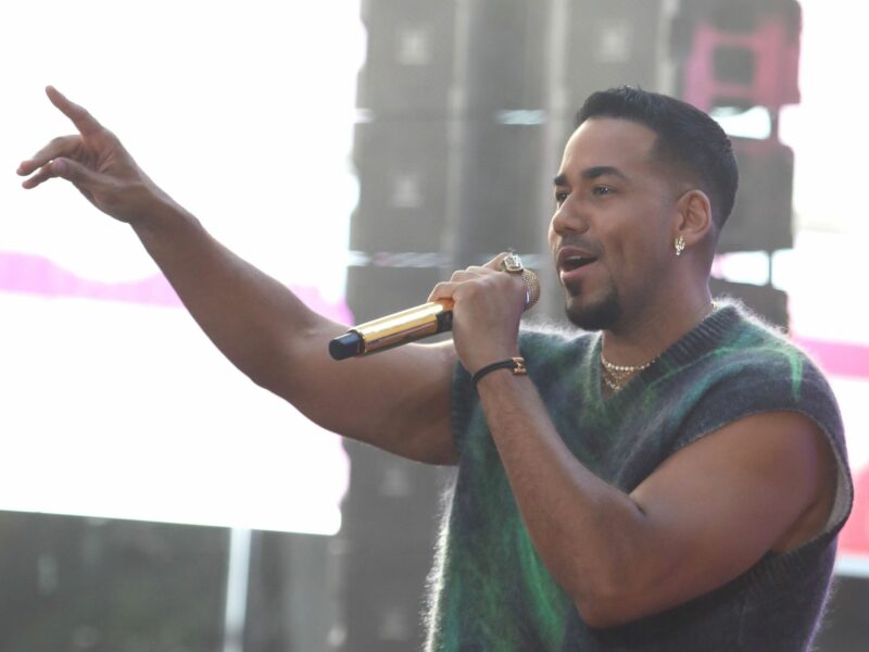 Image of singer Romeo Santos singing on stage.