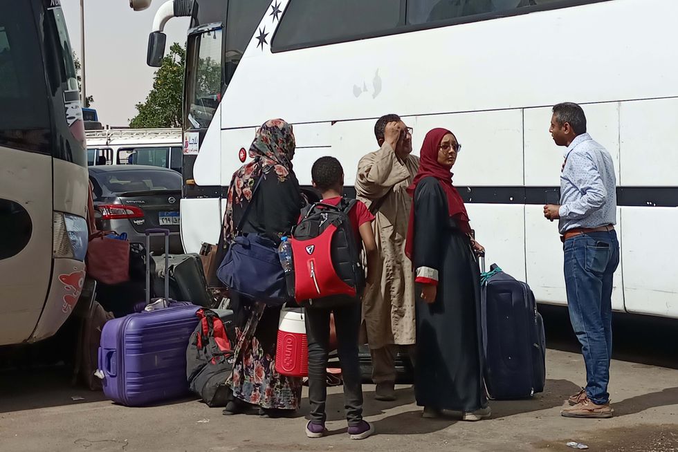 Image of Sudanese refugees arriving at a bus station in Aswan, Egypt.