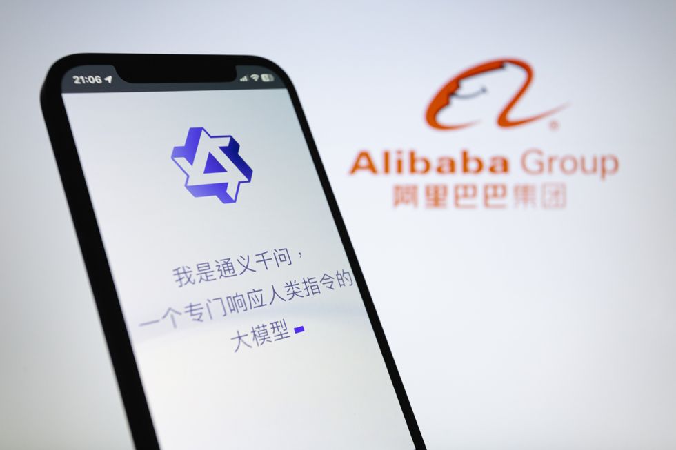 Image of Tongyi Qianwen preview displayed on a smartphone backdropped by Alibaba Group logo