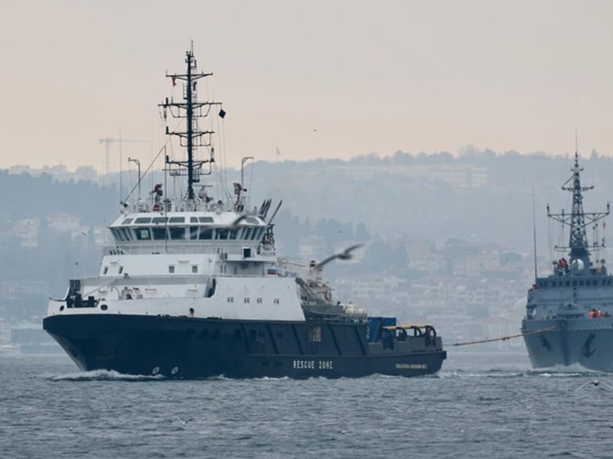 Image of two boats, one rescuing the other.