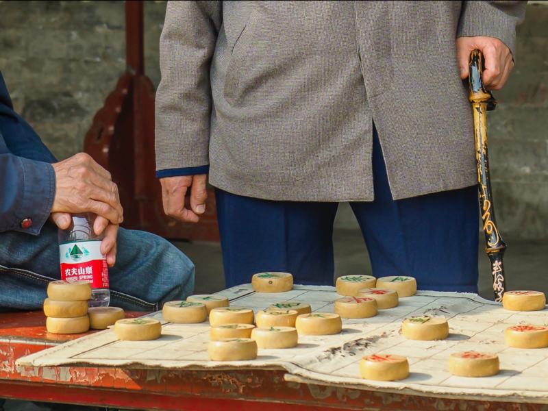 Image of two senior men playing chinese Checkers.