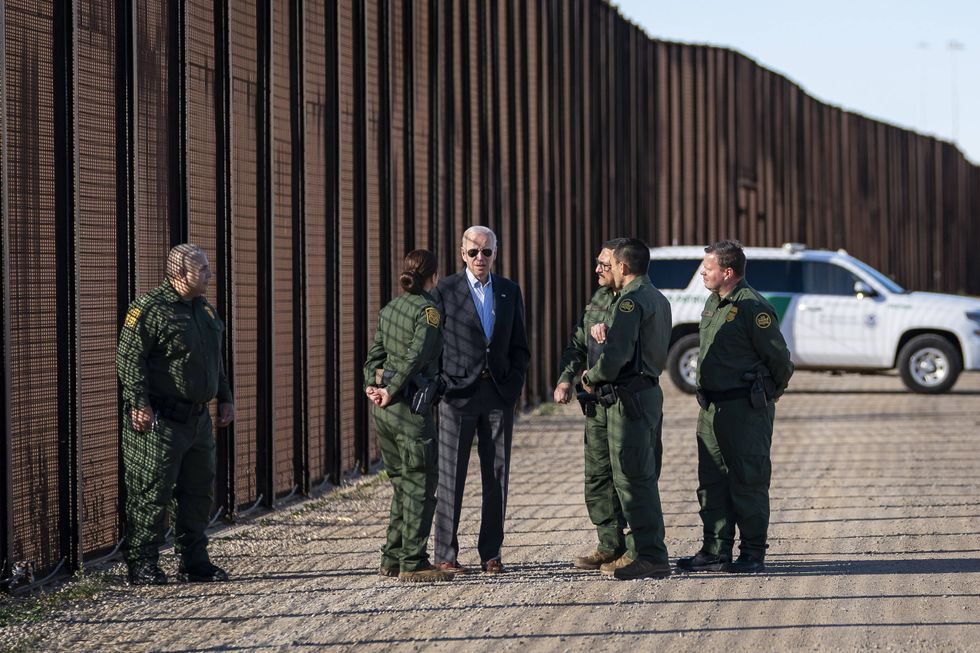 Image of U.S President Joe Biden talking with Custom and Border Patrol officers during a visit to the border wall along the Rio Grande, in El Paso, TX, United States of America.