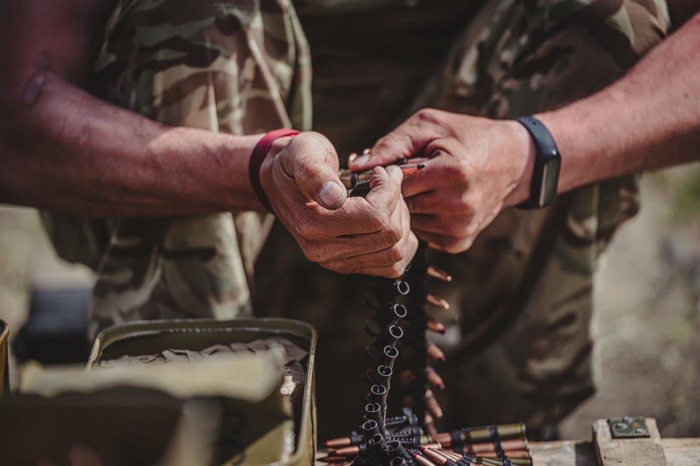 Image of Ukrainian soldier reloading bullets