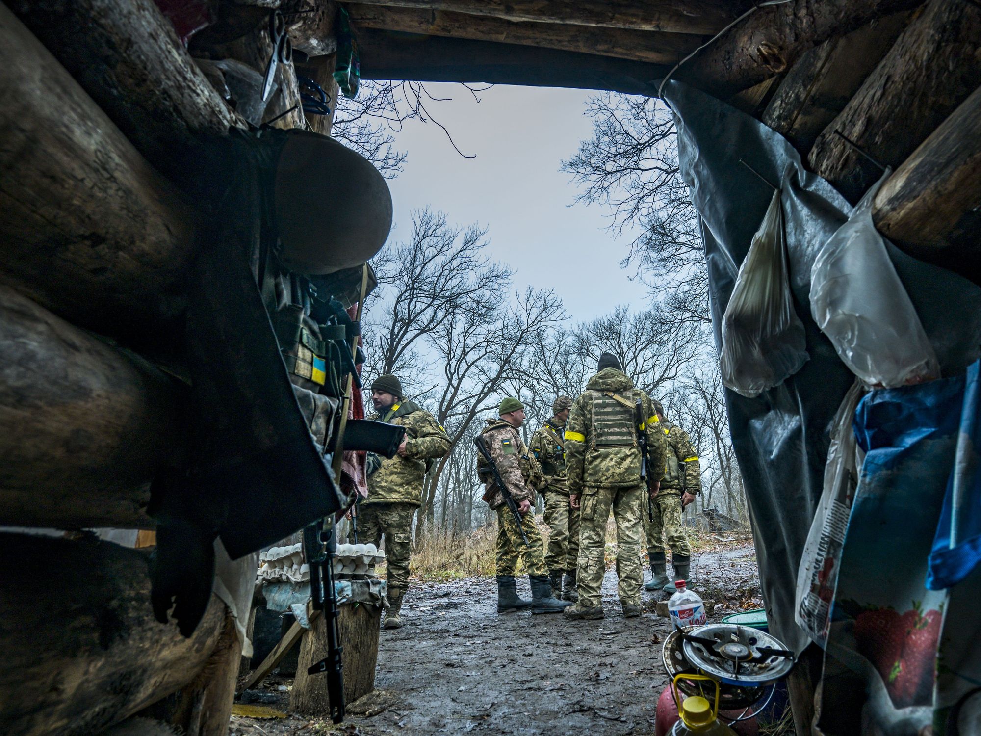 Image of Ukrainian soldiers gathered in their camp in the middle of a forest.