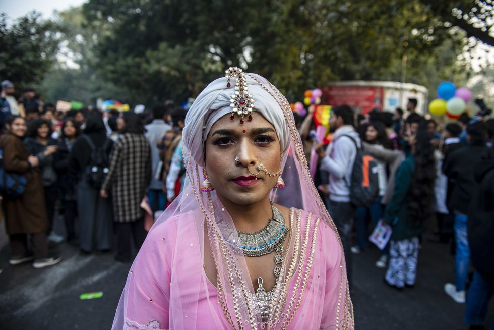 Image showing a drag queen participating in New Delhi's pride parade. She is dressed in a pink gown.