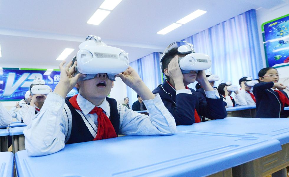 Image showing students learning different subjects with virtual reality technology at the first VR classroom in Zhengzhou.