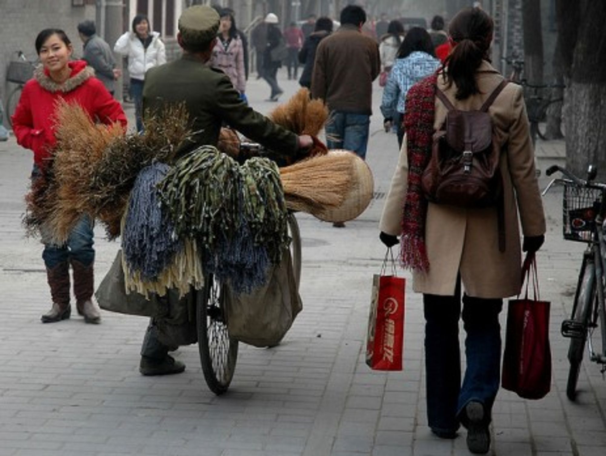 In Beijing, people moving in different directions -- the rich increasingly, abroad. (sherrattsam)