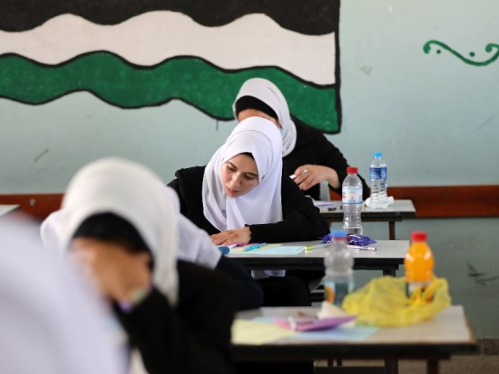 In Gaza City, Palestinian students sit for their final high school exams, known as “Tawjihi,” that will qualify them to enter college