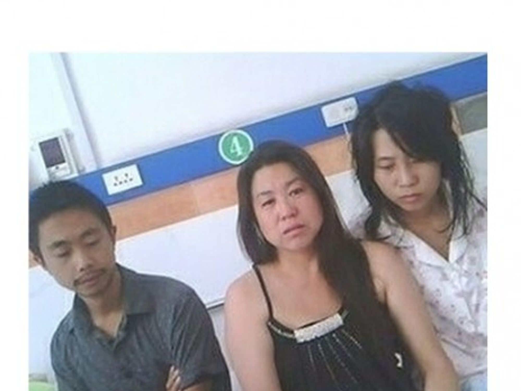 In one of the widely circulated photos, Feng Jianmei (rt) with her brother and sister-in-law after the forced abortion