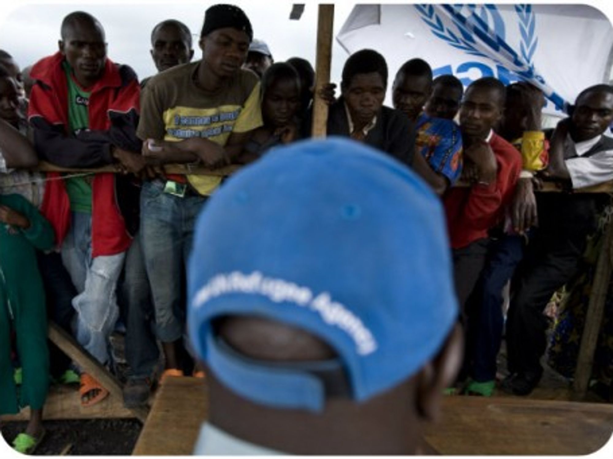 In this file photo in Goma, internally displaced Congolese line up for aid