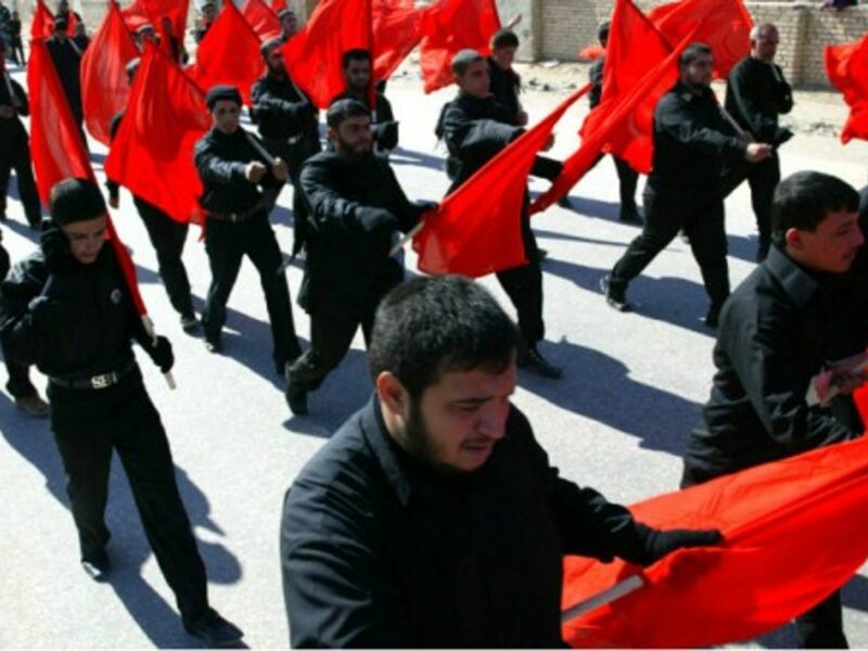 In this file photo, Shia militia march through the holy city of Najaf, Iraq