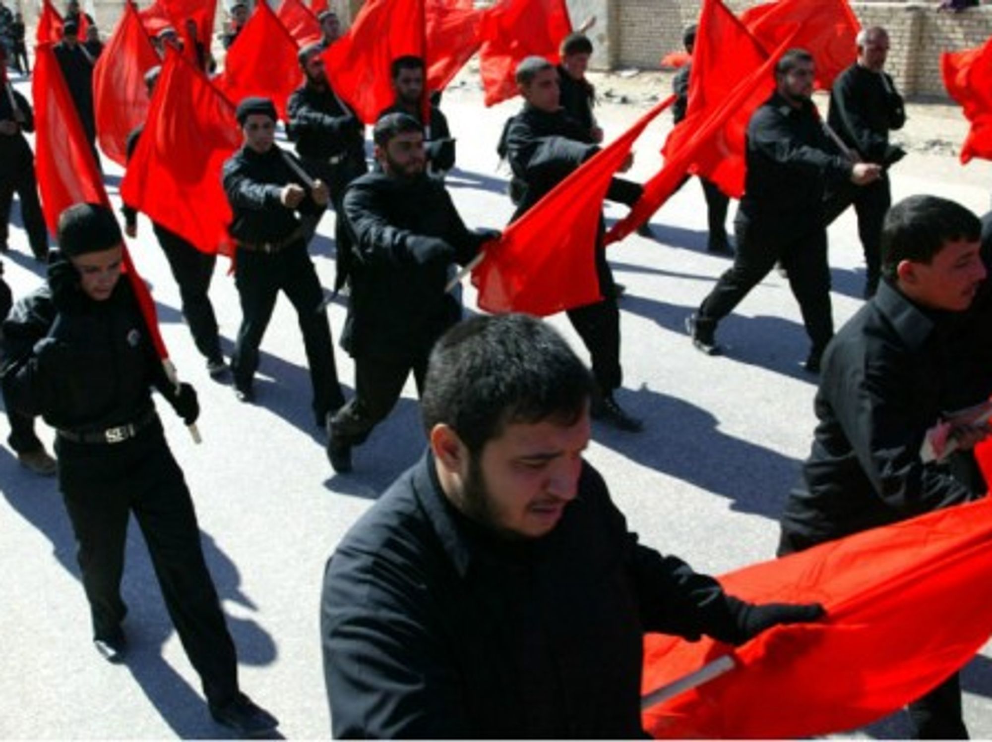 In this file photo, Shia militia march through the holy city of Najaf, Iraq