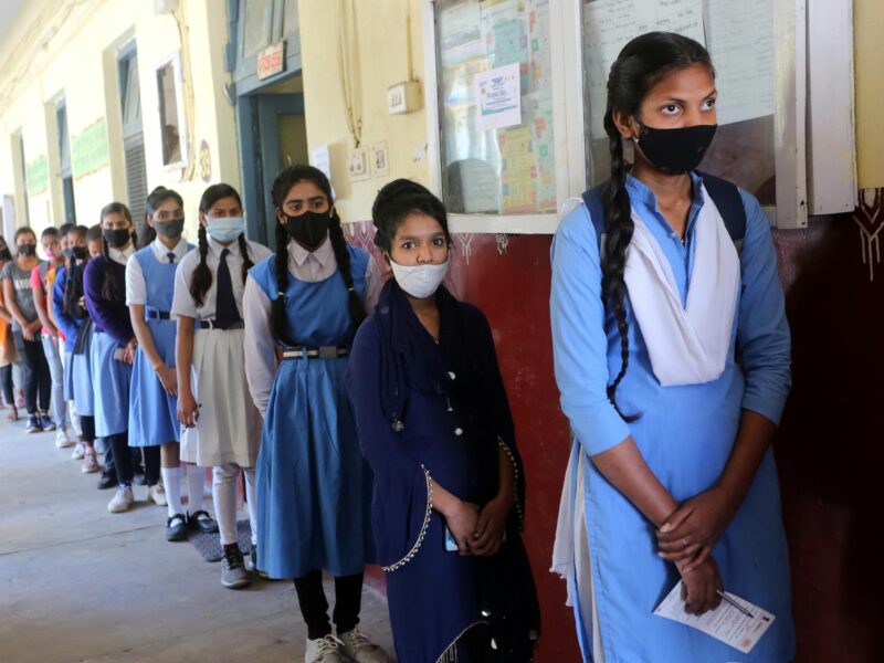 India: Teenage students stand in a queue to receive a dose of COVID-19 vaccine at a school-turned vaccination center
