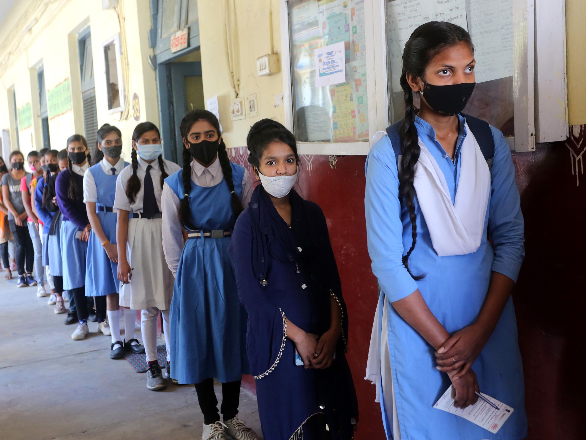 India: Teenage students stand in a queue to receive a dose of COVID-19 vaccine at a school-turned vaccination center