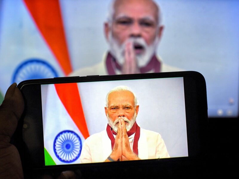 Indian Prime Minister, Narendra Modi speaking to the nation on a smartphone​.