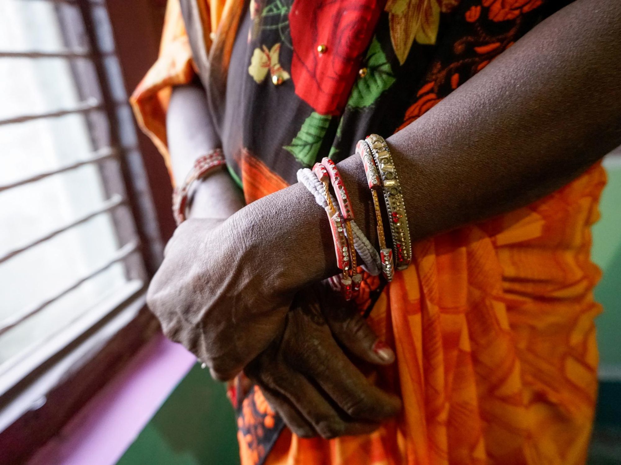 Indu, standing at her neighbor’s home in Nepal, chose to abort her female fetus