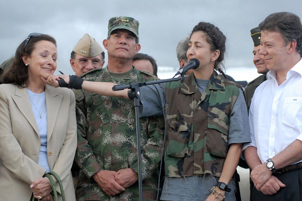 INGRID BETANCOURT (2nd R), who was captured as hostage in February 2002 during a presidential campaign, speaks beside her mother (1st L),