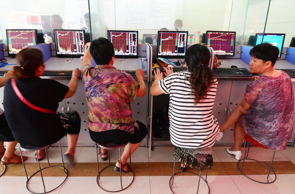 Investors stay at a stock trading hall in Fuyang, east China's Anhui Province
