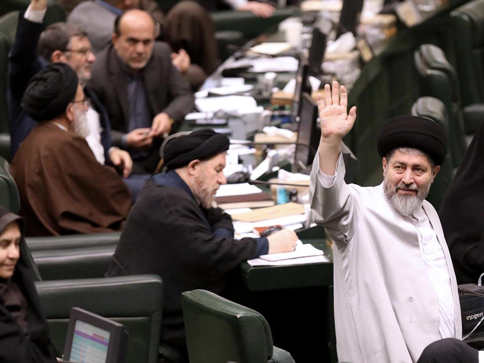 Iranian lawmakers attend an open session of the parliament.
