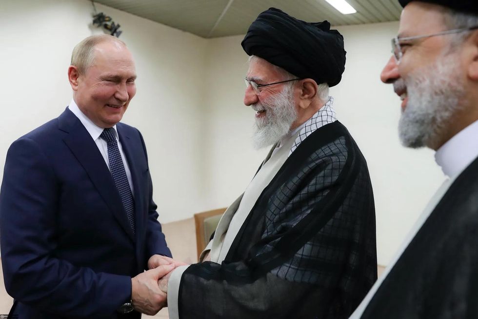 Iranian Supreme Leader Ayatollah Ali Khamenei receiving Russian President Vladimir Putin in the presence of his Iranian counterpart Ebrahim Raisi (right) in Tehran