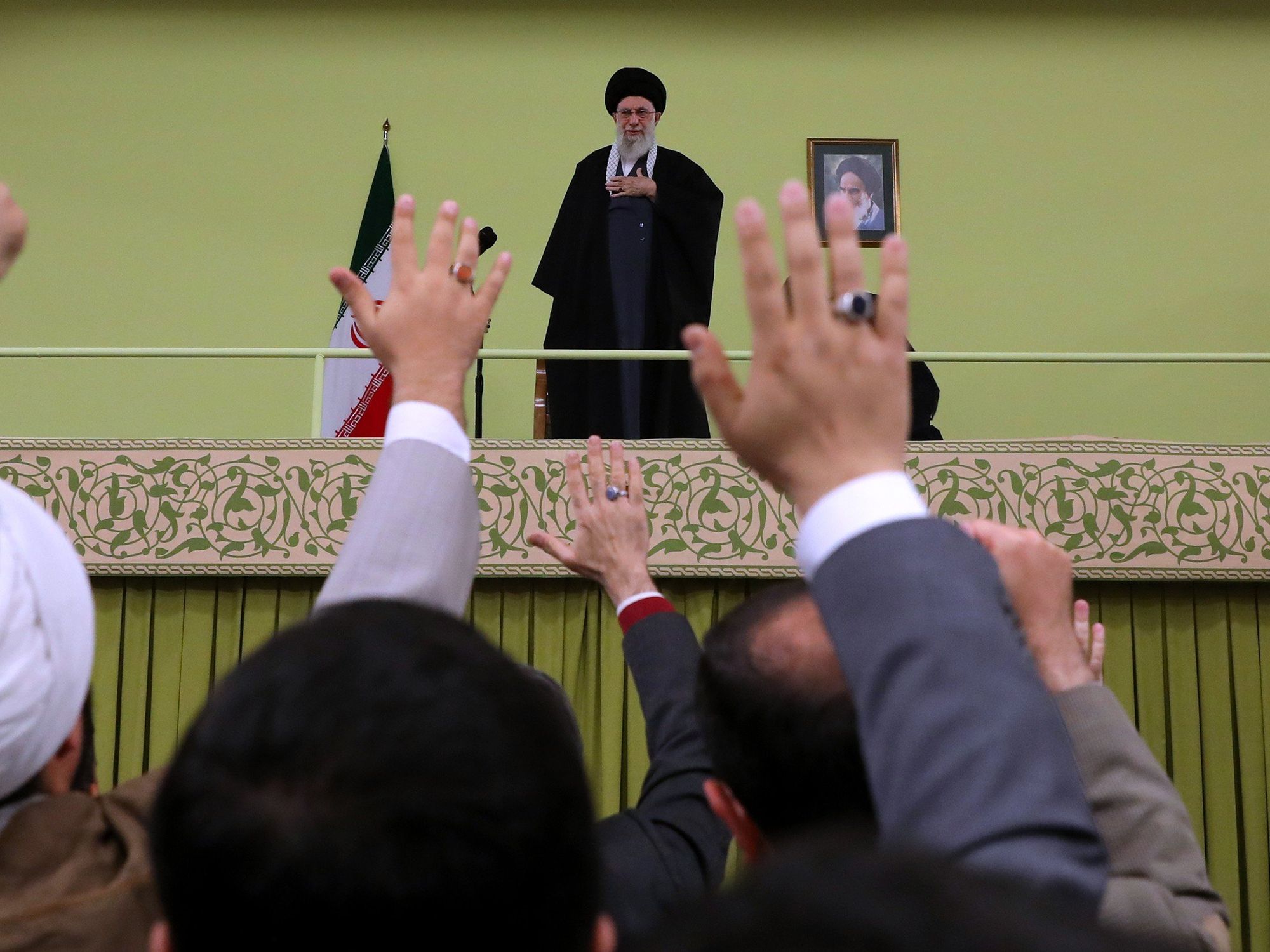 Iranian Supreme Leader Ayatollah Ali Khamenei stands as people greet him ahead of his annual speech to mark Persian New Year​.
