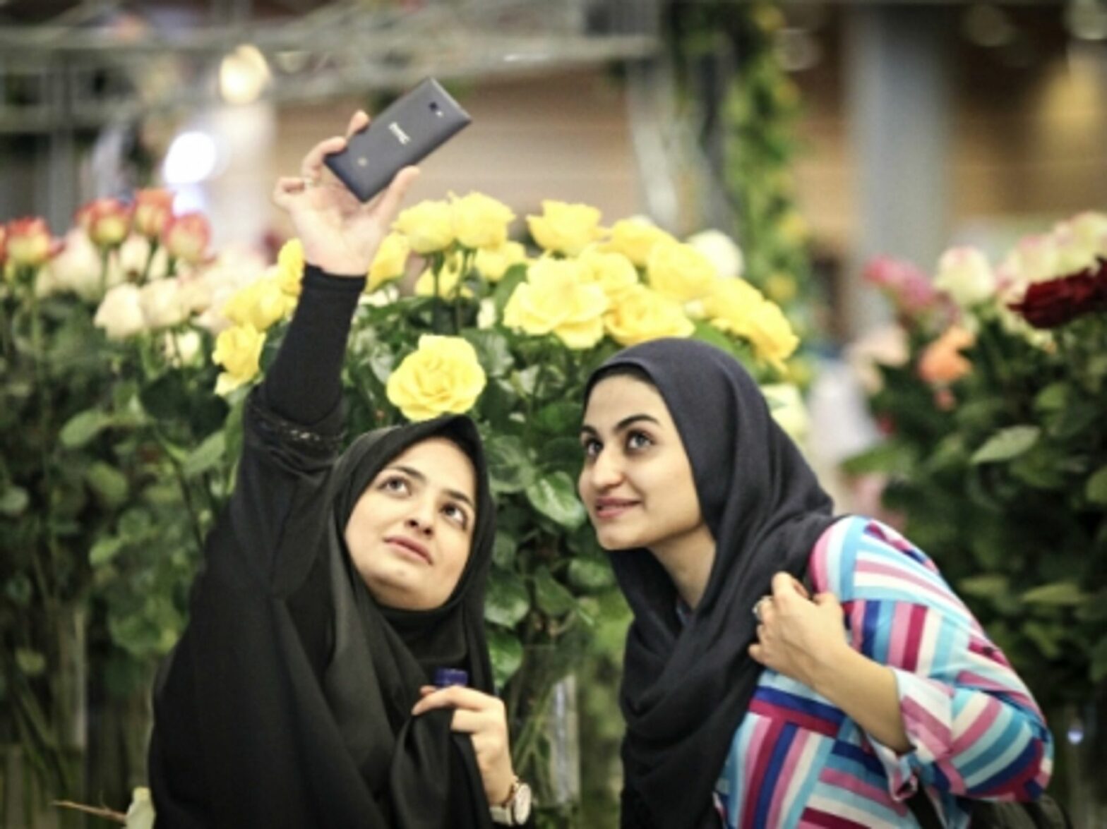 Iranian women taking a selfie at Tehran's International Flower Exhibition on May 13