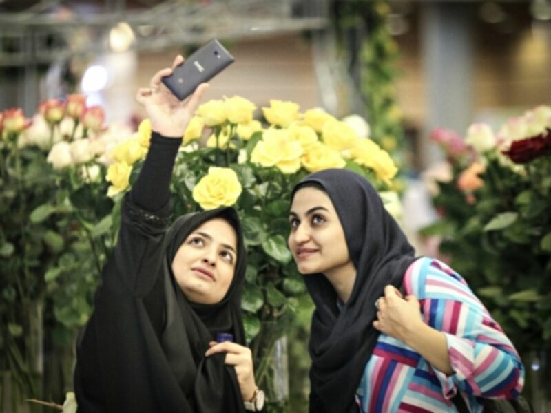 Iranian women taking a selfie at Tehran's International Flower Exhibition on May 13