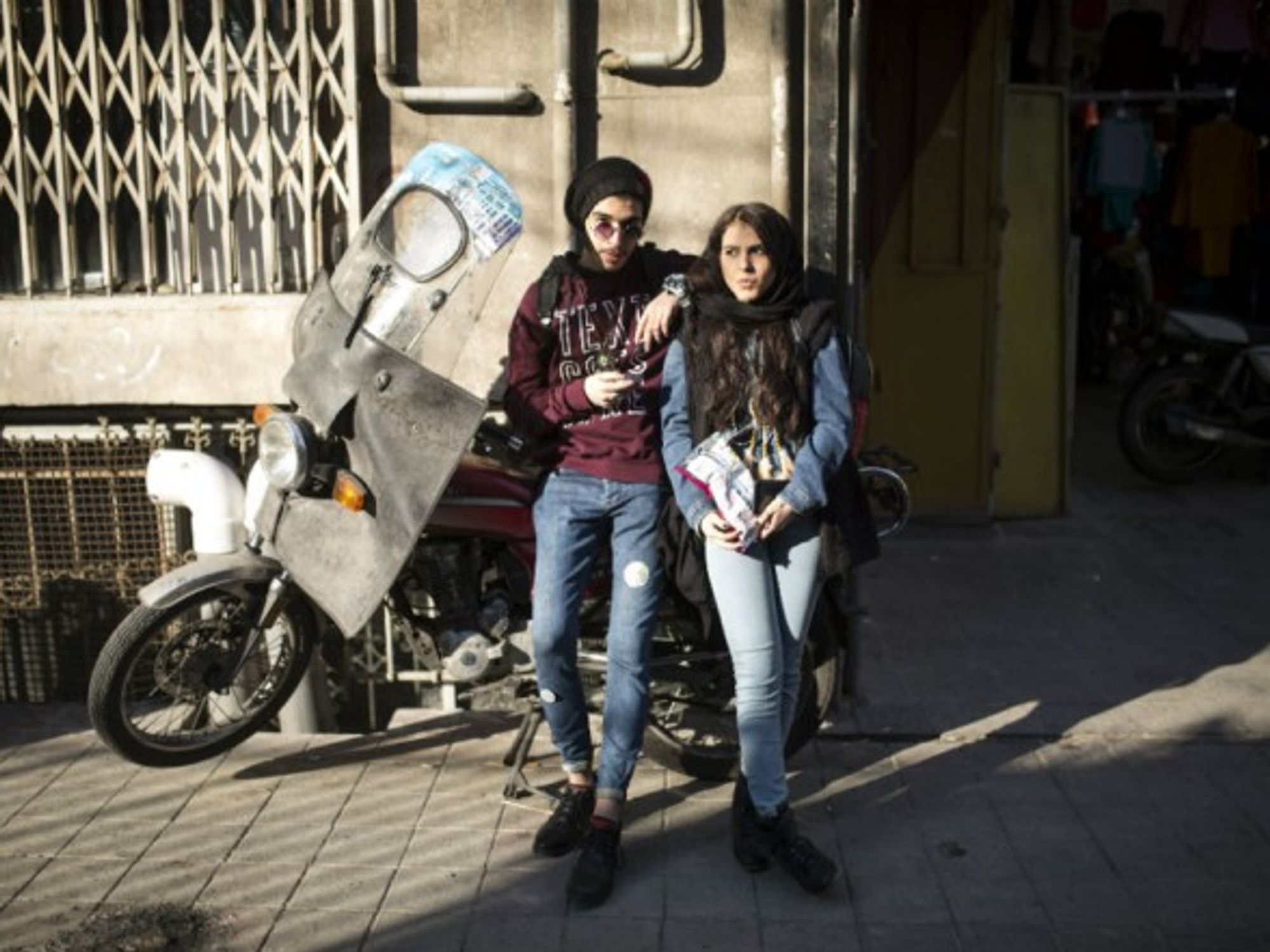 Iranian youth spend time at an alley in downtown Tehran
