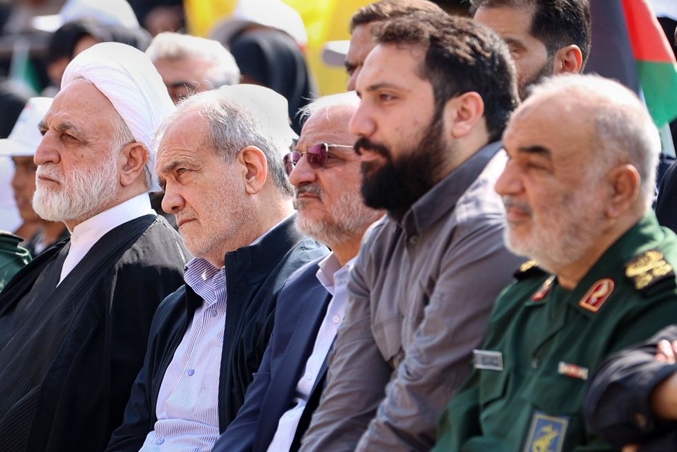 Iran's President Masoud Pezeshkian (2L), Judiciary Chief Gholam Hossein Mohseni Ejei (L), and Islamic Revolutionary Guard Corps (IRGC) commander-in-chief Hossein Salami (R) attend the funeral of Iran's Islamic Revolutionary Guards commander Abbas Nilforoushan in Tehran on October 15, 2024.
