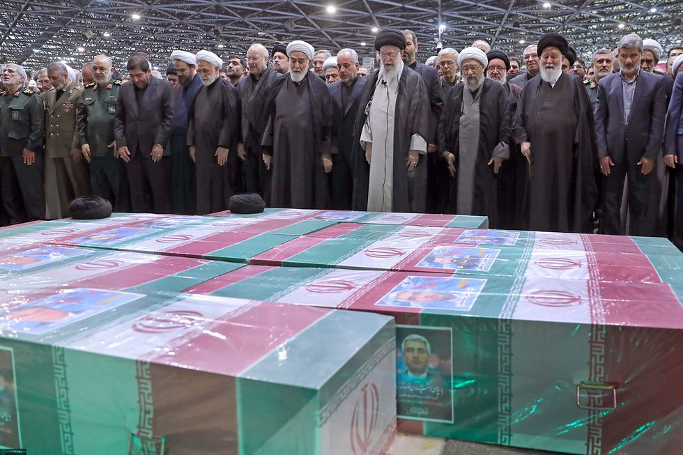 Iran's Supreme Leader Ayatollah Ali Khamenei praying over the coffins of late Iranian President Ebrahim Raisi in Tehran on May 22.