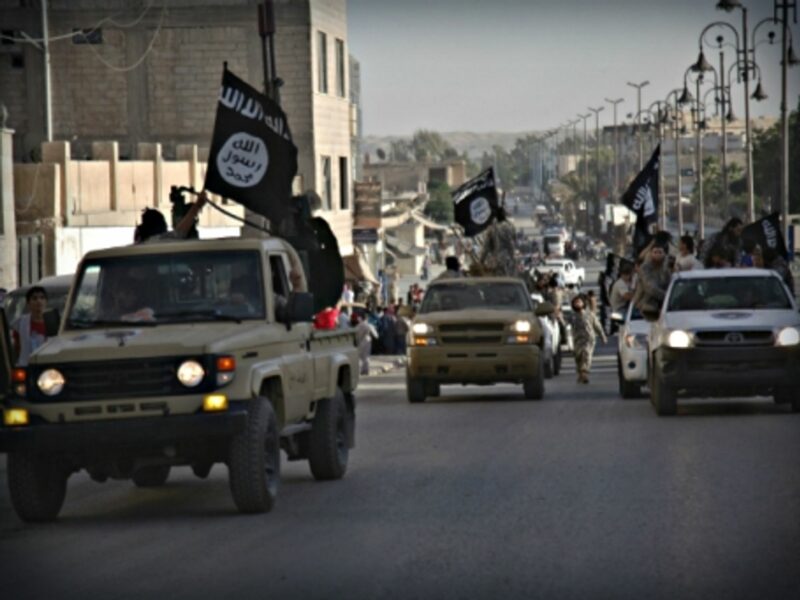 ISIS fighters parading through the streets of Raqqa