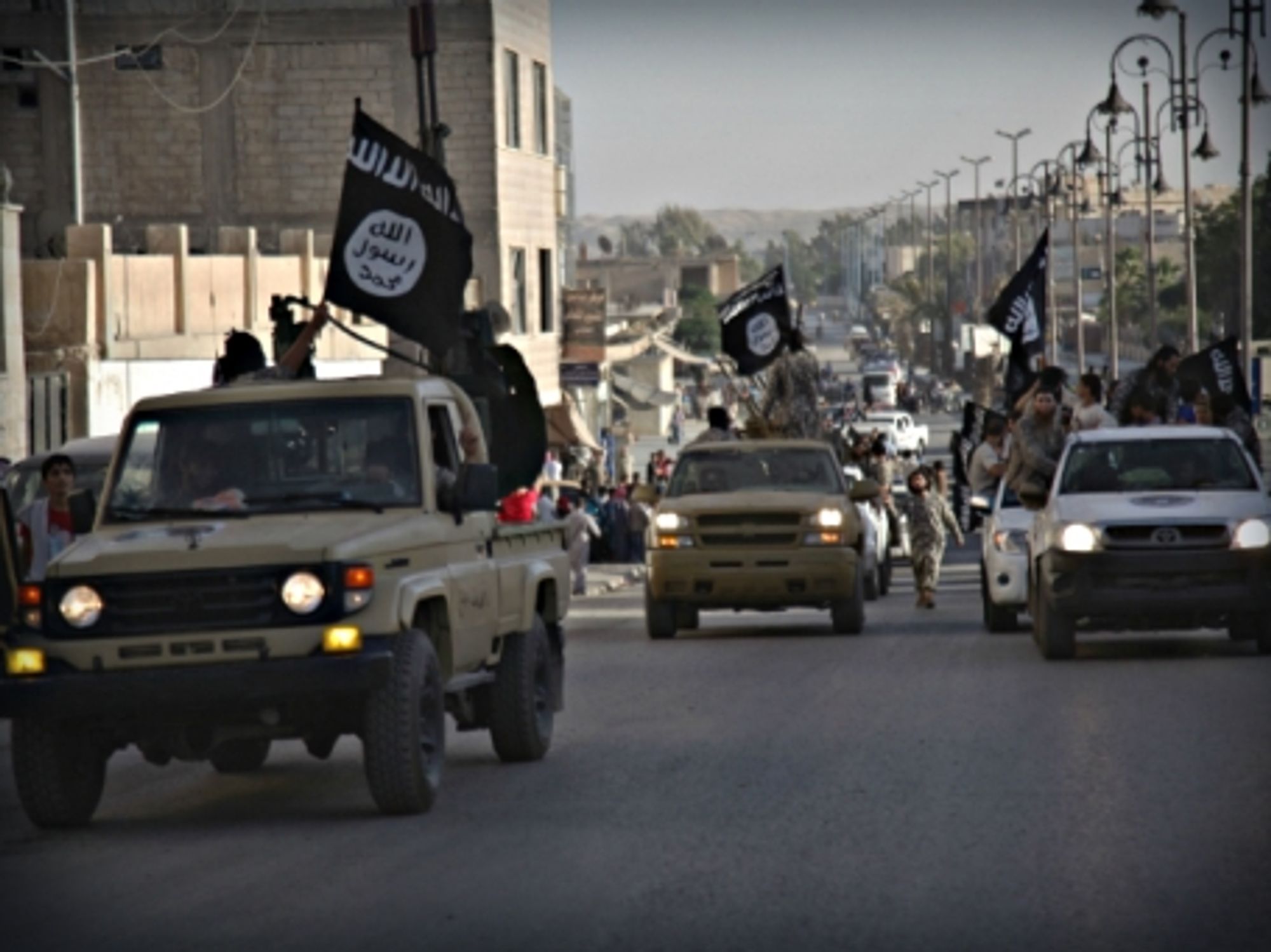 ISIS fighters parading through the streets of Raqqa