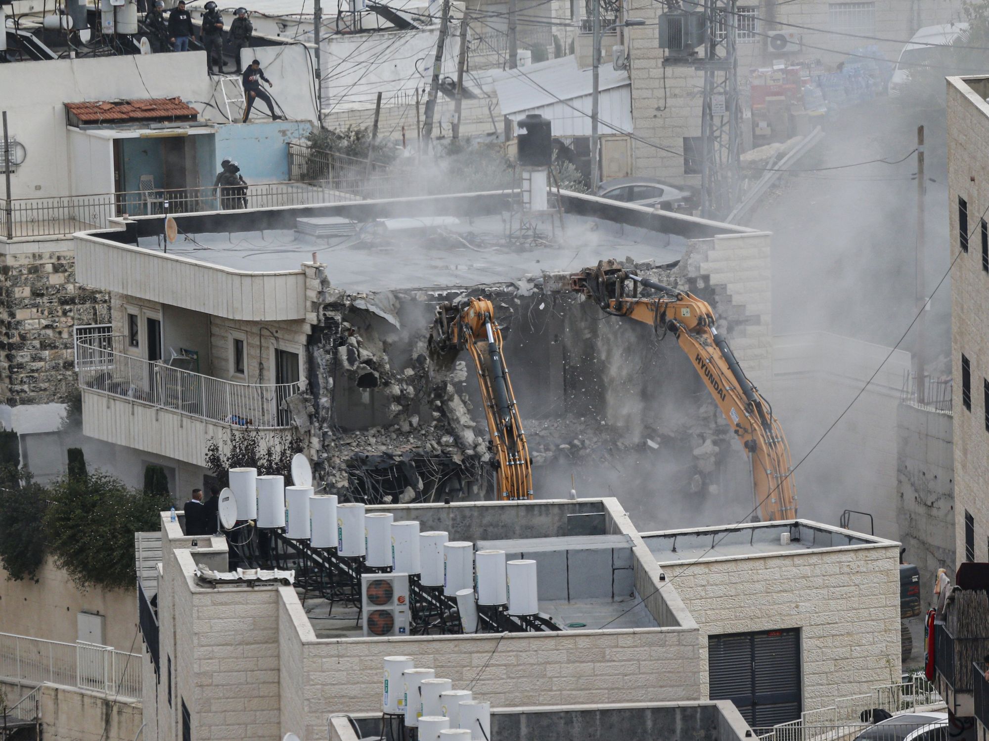 Israeli forces demolish a building belonging to a Palestinian in Jerusalem.