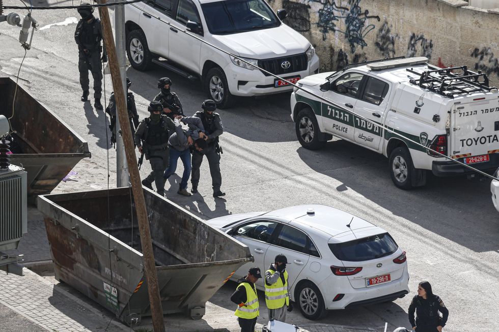 Israeli forces detaining Palestinians protestor