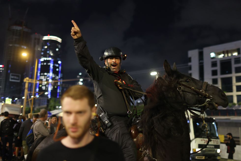 Israeli mounted police disperse a protest by relatives and supporters of hostages held by Hamas, calling on the Israeli government to agree to a ceasefire deal with Hamas.