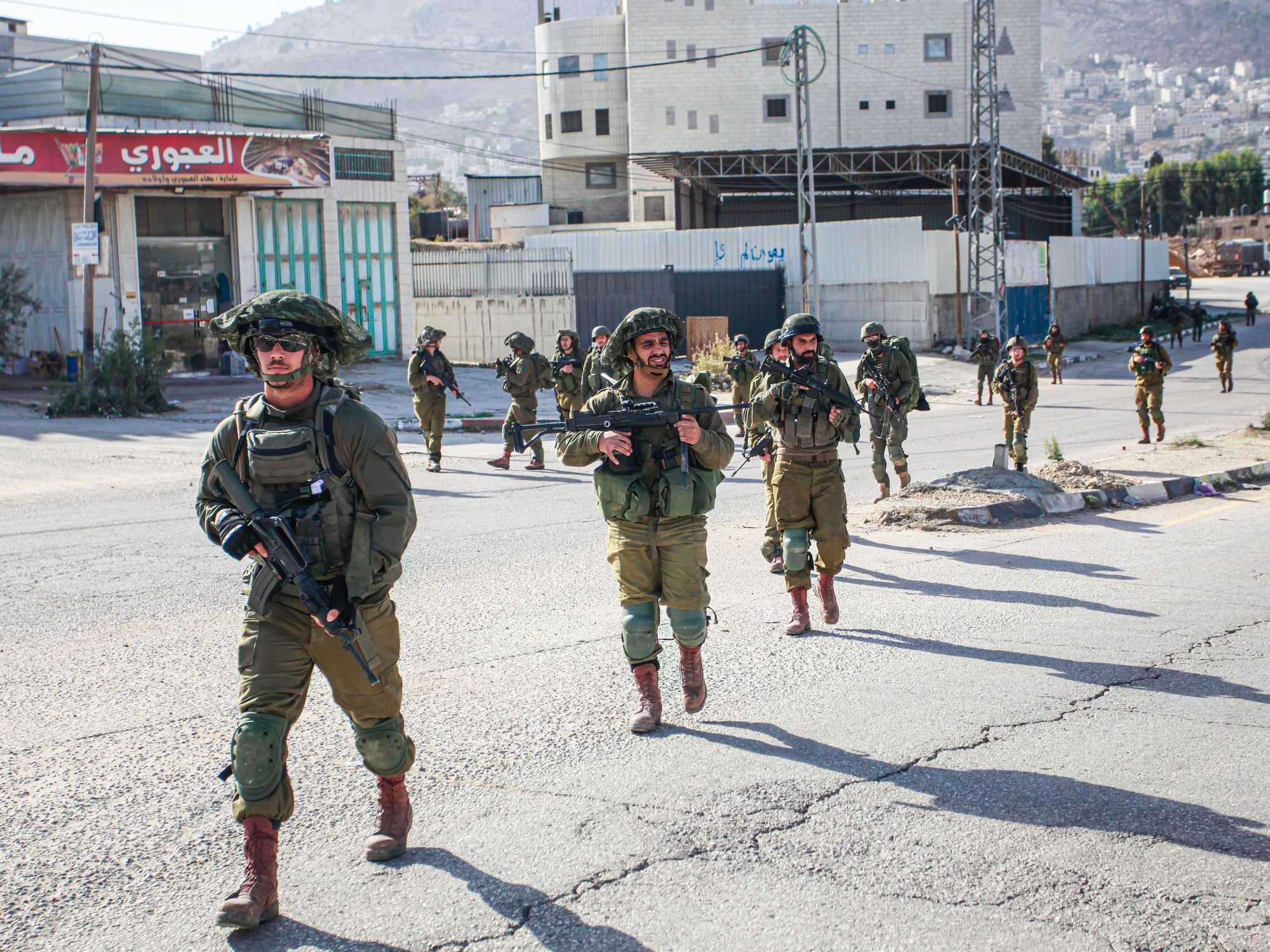 Israeli soldiers on foot storm the Balata refugee camp during a large-scale raid.