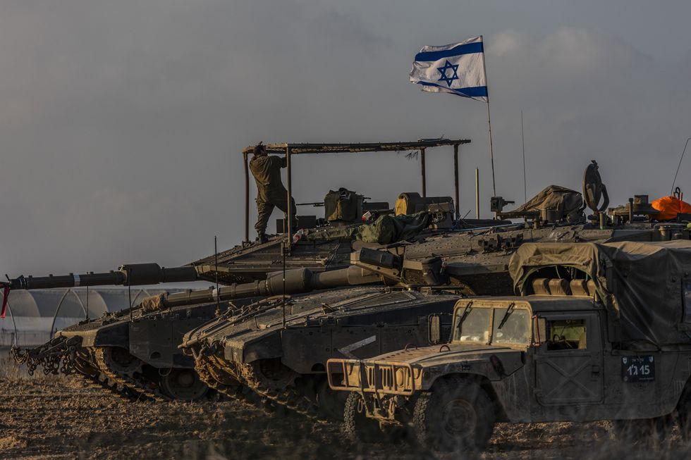 Israeli tanks move near the Israel-Gaza border after the end of a seven-day truce between Israel and Hamas militants