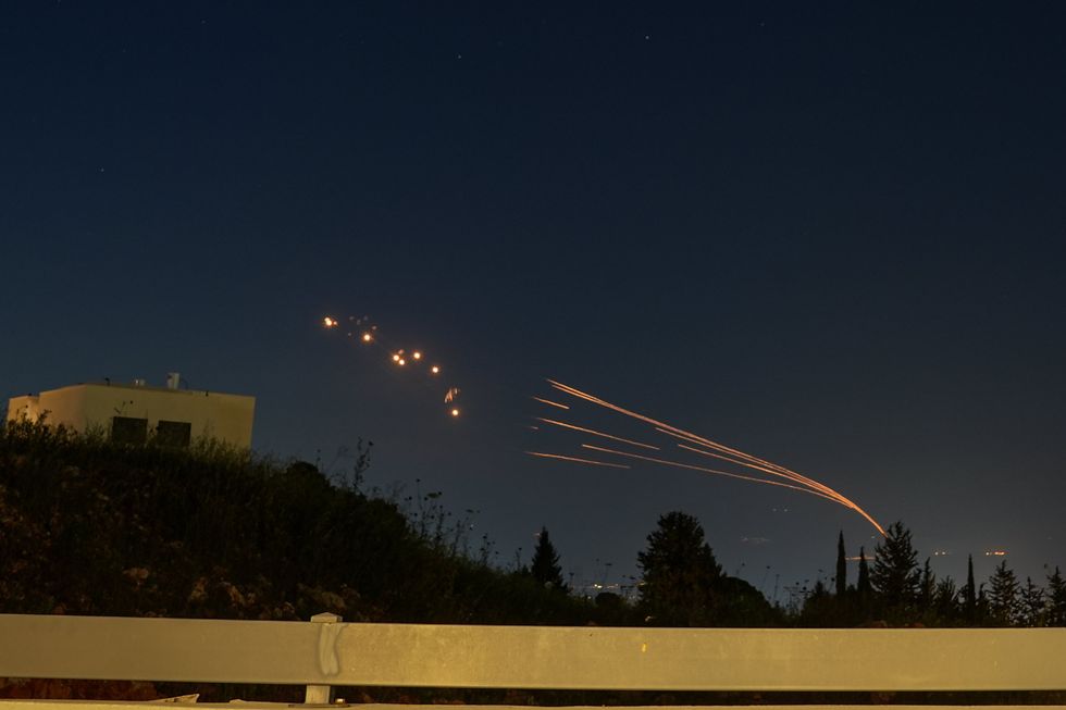 Israel's Iron Dome defense system launches missiles to intercept rockets fired from Lebanon.