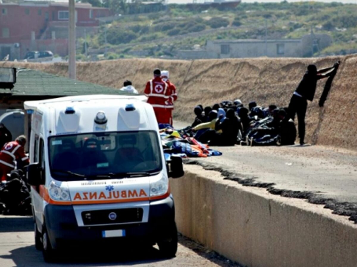 Italian Red Cross members helping migrants in Lampedusa