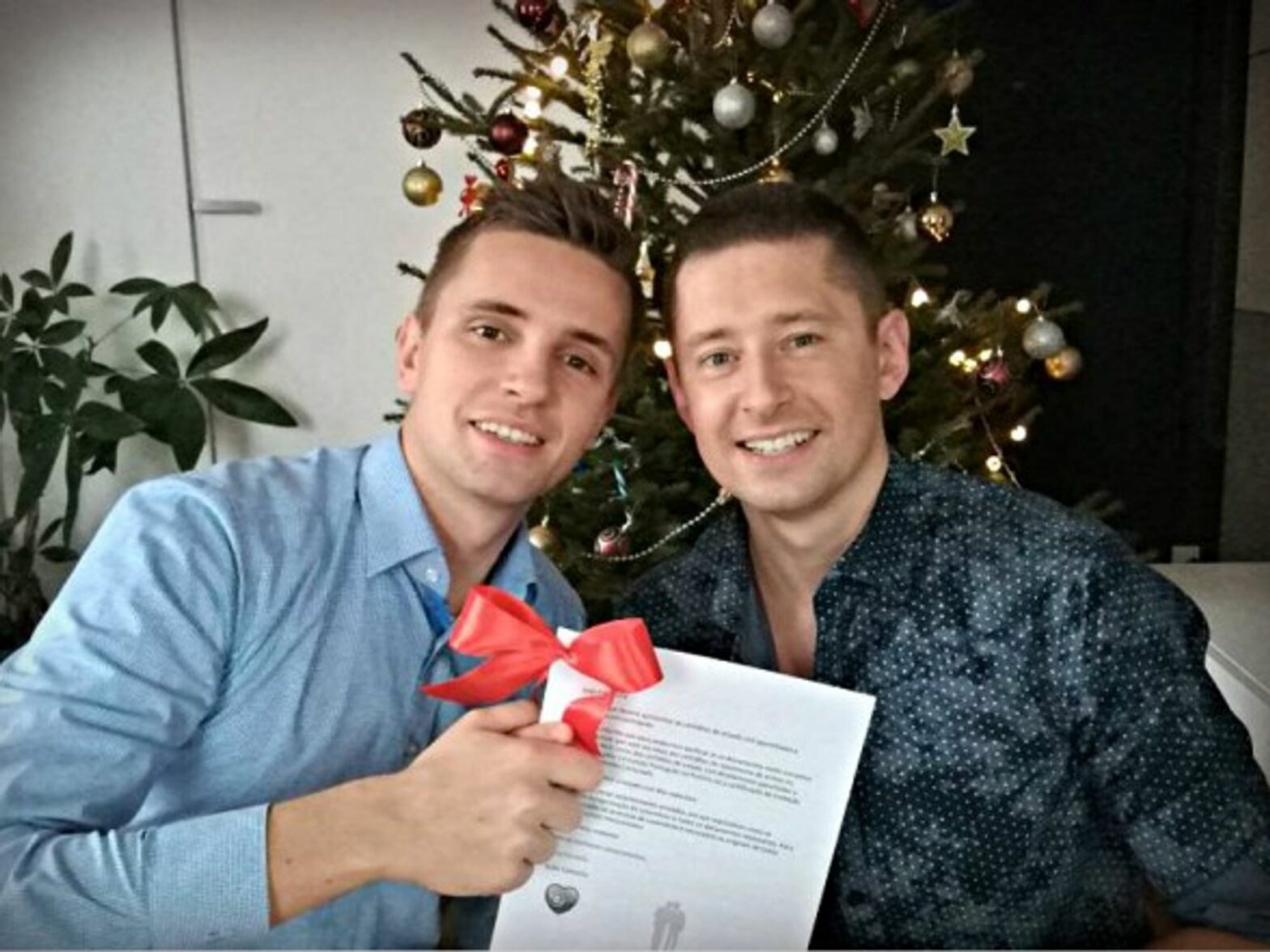 Jakub and Dawid with their marriage certificate