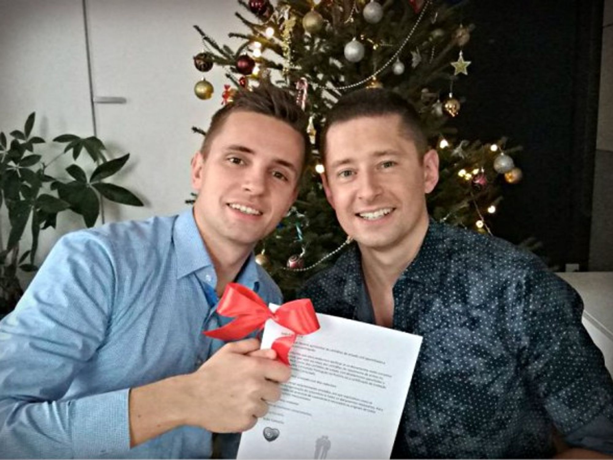 Jakub and Dawid with their marriage certificate