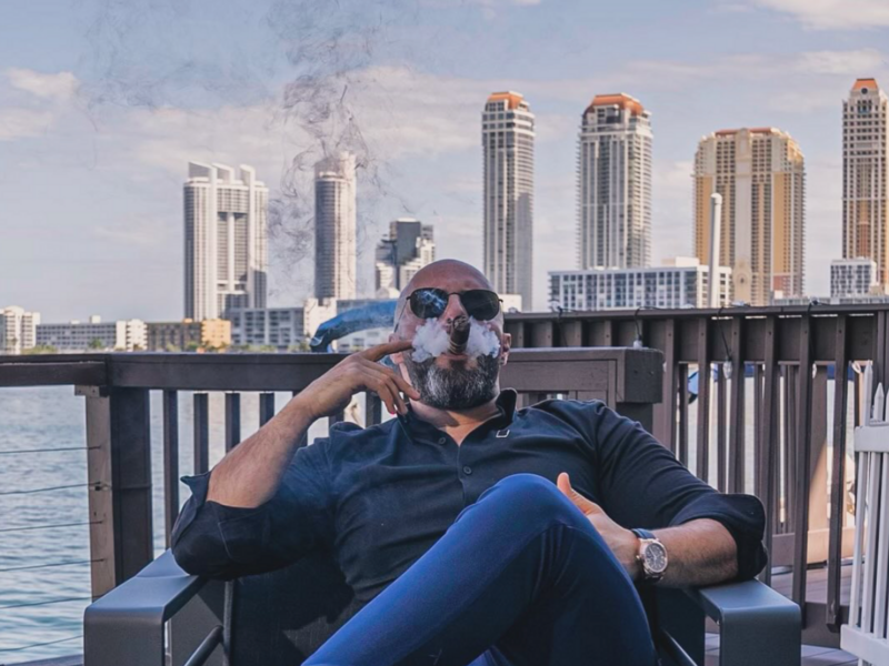Jalal Abuimweis, a CEO in Miami, smoking a cigar.