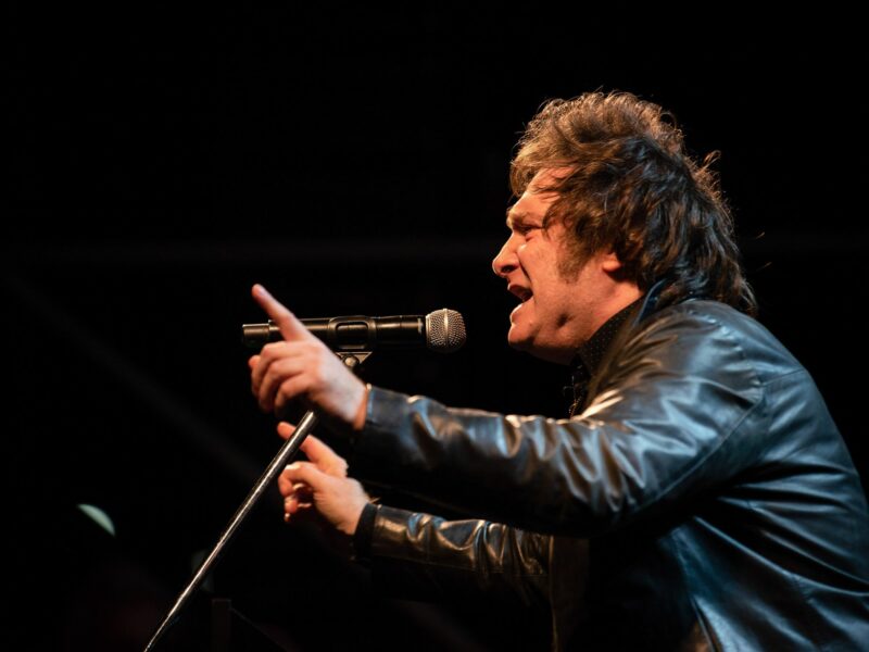 Javier Milei speaks passionately into a microphone