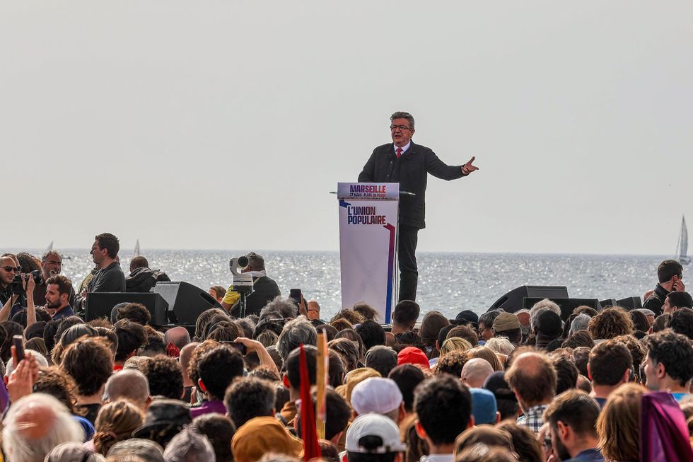 Jean-Luc Mélenchon stands in front of partisans at a meeting in Marseille in March 2022.